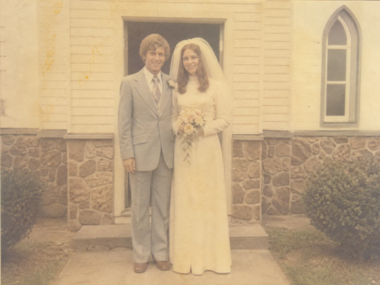 Faded wedding photo before AI restoration
